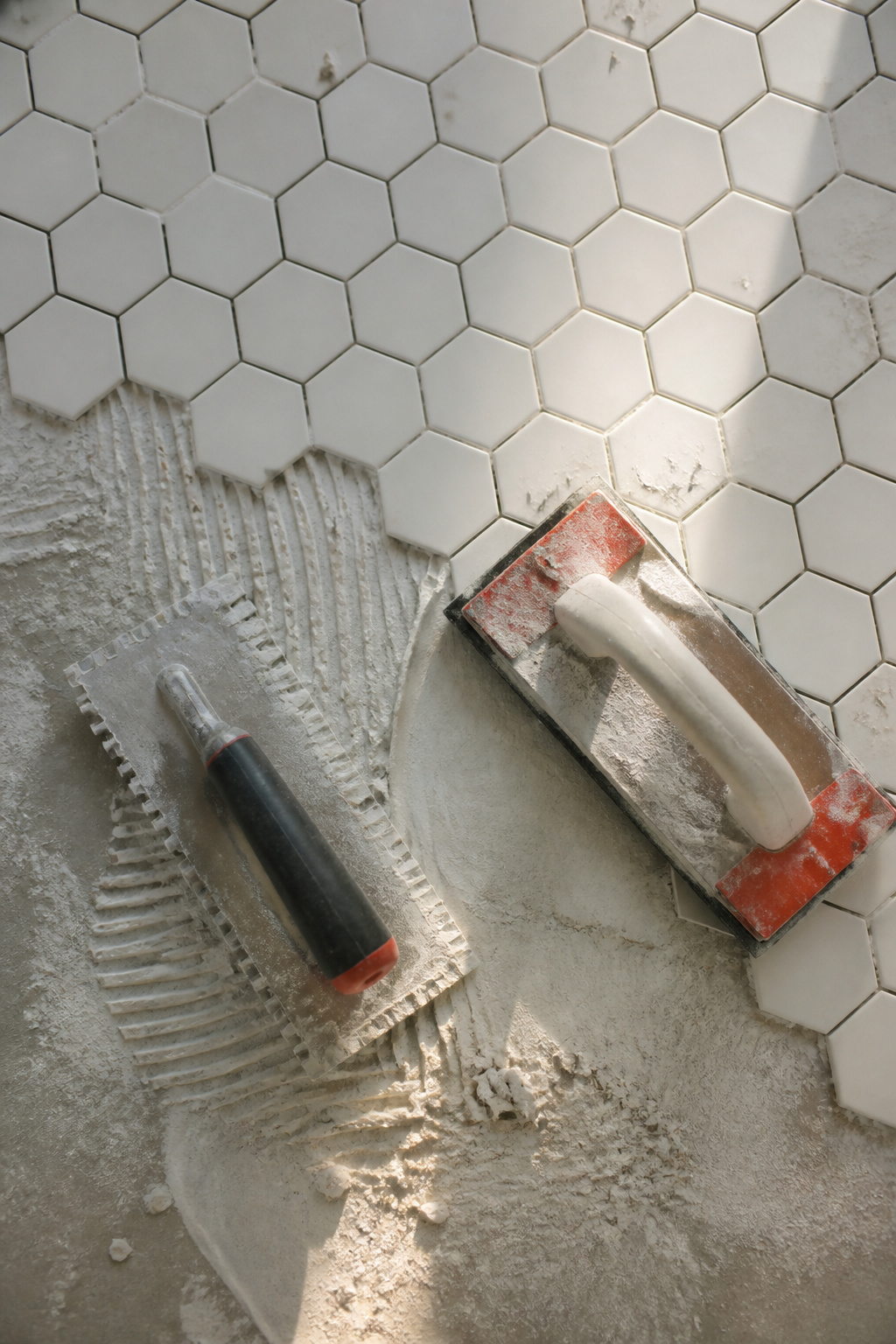 White Hexagon Tile Floor: Materials, Specs and Installation Guide 7 Rubi Jagged Trowel and Pro Rubber Grout Float for tile installation.