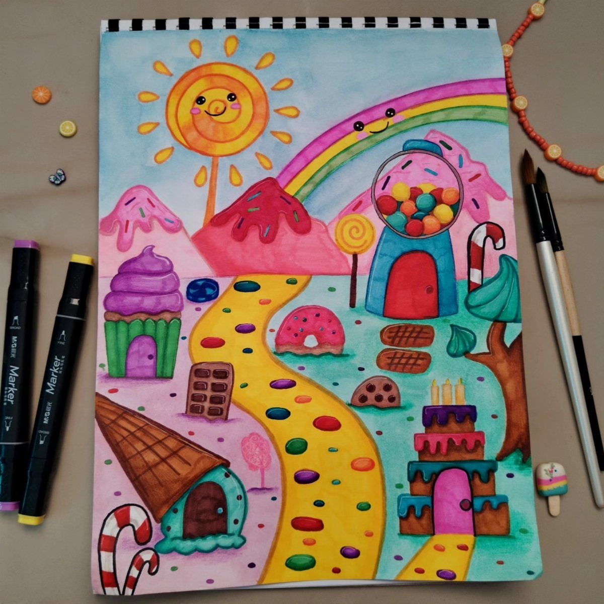 A colorful watercolor drawing of a whimsical candy land landscape with sweets and a rainbow.